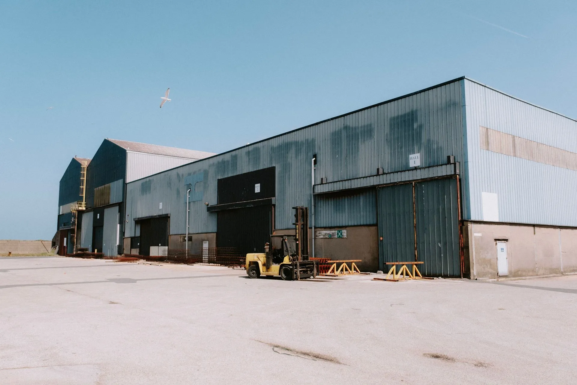 Forklift outside an industrial warehouse, representative photography