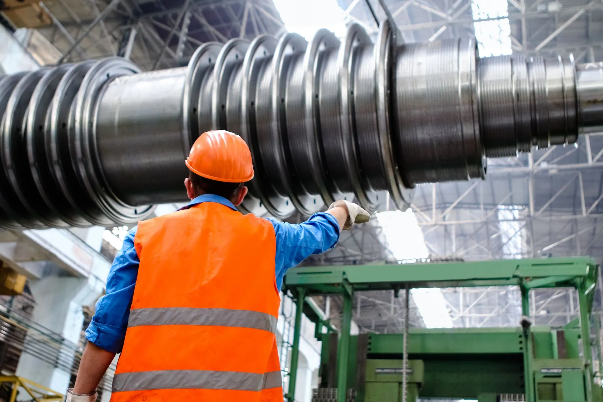 Engineer inspecting industrial equipment, representative photography
